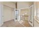 Hallway featuring neutral carpet and a view of the chandelier and open floor plan through french doors at 638 W Nido Ave, Mesa, AZ 85210