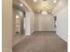 Spacious living room featuring soft carpet, chandelier, and seamless flow into the entryway at 638 W Nido Ave, Mesa, AZ 85210