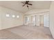 Spacious carpeted main bedroom with vaulted ceilings, ceiling fan, and multiple entry points at 638 W Nido Ave, Mesa, AZ 85210