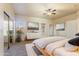 Bright main bedroom featuring a ceiling fan, light walls, and a sliding door to outdoor space at 638 W Nido Ave, Mesa, AZ 85210