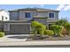 Two-story house with gray siding, landscaping, and a two-car garage at 7180 W Tombstone Trl, Peoria, AZ 85383