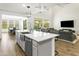 Open concept kitchen with large island, stainless steel appliances, and white quartz countertops at 7180 W Tombstone Trl, Peoria, AZ 85383