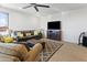 Bright living room featuring a fireplace and flat-screen TV at 7180 W Tombstone Trl, Peoria, AZ 85383