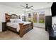 Large main bedroom with wooden bed frame, ceiling fan, and ample natural light at 7180 W Tombstone Trl, Peoria, AZ 85383