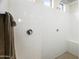 Large walk-in shower with bright white tile and built-in bench seat at 7180 W Tombstone Trl, Peoria, AZ 85383