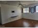 Bedroom with wood-look flooring, ceiling fan, and TV wall mount at 720 N 82Nd St # E210, Scottsdale, AZ 85257