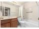 Full bathroom with bathtub and wood cabinet at 7373 S Bonarden Ln, Tempe, AZ 85283