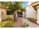 Small courtyard with a tree, patio furniture, and pathway at 7373 S Bonarden Ln, Tempe, AZ 85283