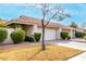 Tan stucco house with tile roof, two-car garage, and neatly trimmed shrubs at 7373 S Bonarden Ln, Tempe, AZ 85283