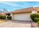 House exterior featuring tan stucco, tile roof, and a two-car garage at 7373 S Bonarden Ln, Tempe, AZ 85283