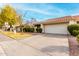 House exterior view showing tan stucco, tile roof, and a two-car garage at 7373 S Bonarden Ln, Tempe, AZ 85283