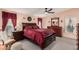 Cozy bedroom with dark wood furniture and red bedding at 7807 E Main St # Cc-106, Mesa, AZ 85207