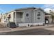 Gray manufactured home with carport and landscaping at 7807 E Main St # Cc-106, Mesa, AZ 85207