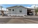 Gray mobile home with carport and landscaping at 7807 E Main St # Cc-106, Mesa, AZ 85207