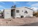 Gray mobile home with carport and landscaping at 7807 E Main St # Cc-106, Mesa, AZ 85207