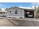 Gray mobile home with carport and landscaping at 7807 E Main St # Cc-106, Mesa, AZ 85207