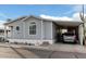 Gray mobile home with carport and landscaping at 7807 E Main St # Cc-106, Mesa, AZ 85207