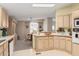 Kitchen with light wood cabinets and a view into the dining area at 7807 E Main St # Cc-106, Mesa, AZ 85207