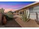 Desert landscaping, covered patio, and cactus plants highlight this backyard at 8309 E Navarro Ave, Mesa, AZ 85209