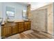 Double vanity bathroom with stone sinks, walk-in shower, and wood cabinets at 8309 E Navarro Ave, Mesa, AZ 85209