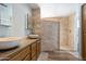 Bathroom with walk-in shower, vessel sink, and wood cabinets at 8309 E Navarro Ave, Mesa, AZ 85209