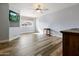 Bright bedroom with wood floors, a large window, and a ceiling fan at 8309 E Navarro Ave, Mesa, AZ 85209