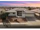 Single-story home with desert landscaping and a two-car garage at 8309 E Navarro Ave, Mesa, AZ 85209