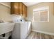 Laundry room with washer, dryer, cabinets, and a utility sink at 8309 E Navarro Ave, Mesa, AZ 85209