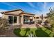 Relaxing backyard patio featuring comfortable seating and a built-in grill at 8729 E Indigo St, Mesa, AZ 85207