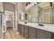 Double vanity bathroom with modern gray cabinets and a large mirror at 8729 E Indigo St, Mesa, AZ 85207