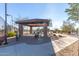 A shaded ramada in a community area with picnic tables and view of the tennis court at 8729 E Indigo St, Mesa, AZ 85207