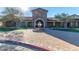 A picturesque view of the community center featuring an inviting entrance, fountain and lush landscaping at 8729 E Indigo St, Mesa, AZ 85207