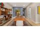 Spacious dining room featuring a long wooden table and built-in shelving at 8729 E Indigo St, Mesa, AZ 85207