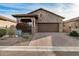 Single-story home with stone accents and a 2-car garage at 8729 E Indigo St, Mesa, AZ 85207