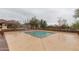 Hot tub with a stone surround and desert landscaping at 8729 E Indigo St, Mesa, AZ 85207