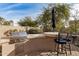 Outdoor kitchen with grill and bar seating at 8729 E Indigo St, Mesa, AZ 85207