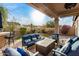 Relaxing covered patio with seating area and fire pit at 8729 E Indigo St, Mesa, AZ 85207