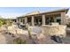 Covered patio with built-in BBQ and seating area, surrounded by desert landscaping at 9321 E Diamond Dr, Sun Lakes, AZ 85248