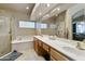 Elegant bathroom with double vanity and soaking tub at 9321 E Diamond Dr, Sun Lakes, AZ 85248