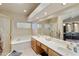 Elegant bathroom with double vanity and soaking tub at 9321 E Diamond Dr, Sun Lakes, AZ 85248