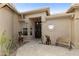 Welcoming courtyard entry with southwestern decor and a wooden bench at 9321 E Diamond Dr, Sun Lakes, AZ 85248