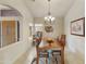 Formal dining room with a wood table and chandelier, offering a warm ambiance at 9321 E Diamond Dr, Sun Lakes, AZ 85248