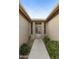 Front entry with an ornate metal gate and well-maintained landscaping at 9321 E Diamond Dr, Sun Lakes, AZ 85248