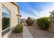 Landscaped side yard with walkway and desert plants at 9321 E Diamond Dr, Sun Lakes, AZ 85248