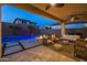 Outdoor entertaining area with pool, fire pit, and seating at 9846 E Resistance Ave, Mesa, AZ 85212