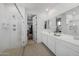 Elegant bathroom with dual vanities, a walk-in shower, and patterned tile floor at 9846 E Resistance Ave, Mesa, AZ 85212