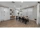 Bright dining room features a farmhouse table with black chairs, chandelier, and hardwood floors at 9846 E Resistance Ave, Mesa, AZ 85212