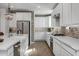 Modern kitchen with white cabinets and a brick accent wall at 9846 E Resistance Ave, Mesa, AZ 85212