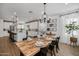 Open concept kitchen with island, white cabinets, and exposed brick at 9846 E Resistance Ave, Mesa, AZ 85212