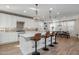 Modern kitchen with white cabinets, a large island, and brick backsplash at 9846 E Resistance Ave, Mesa, AZ 85212